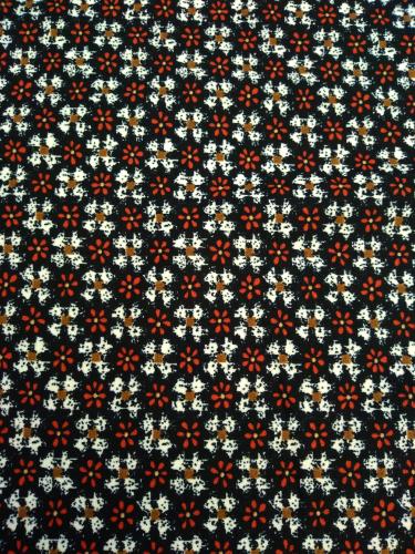Tissu polyester tricot noir fleurs rouge